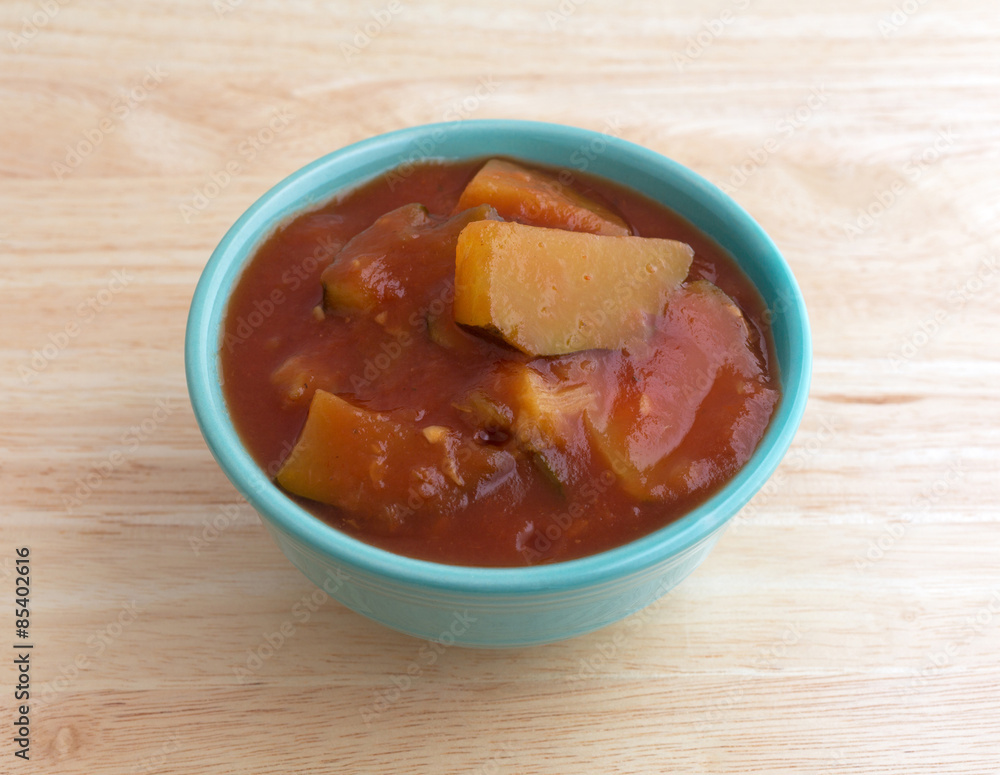 Chunks of zucchini in tomato sauce in bowl Chunks of zucchini in tomato sauce in bowl