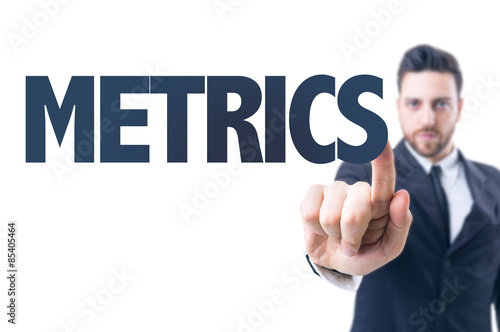 Business man pointing the text: Metrics