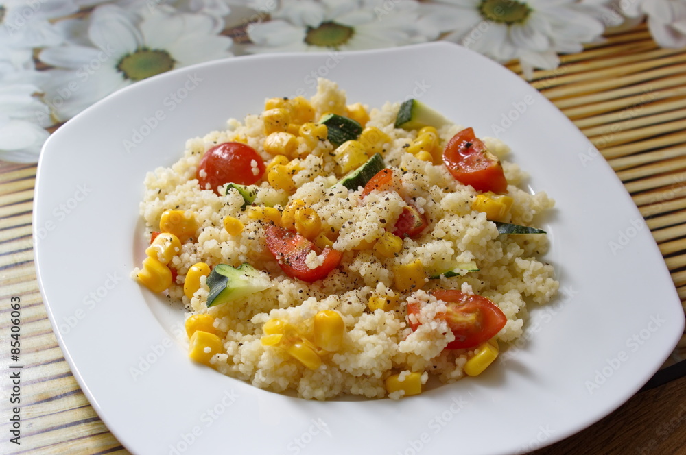 couscous served with corns, zucchini and tomatoes couscous served with corns, zucchini and tomatoes