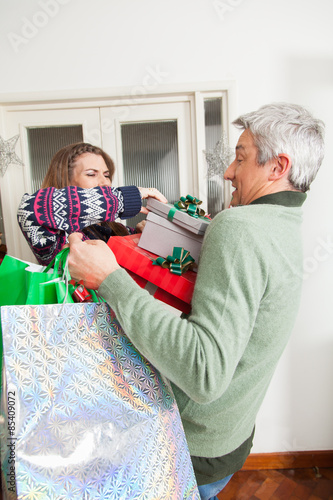 Man holding a lot of gift photo