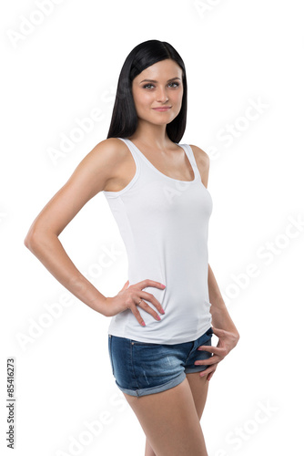 Close-up of a brunette woman holding a hand on the waist. Isolated. © ImageFlow