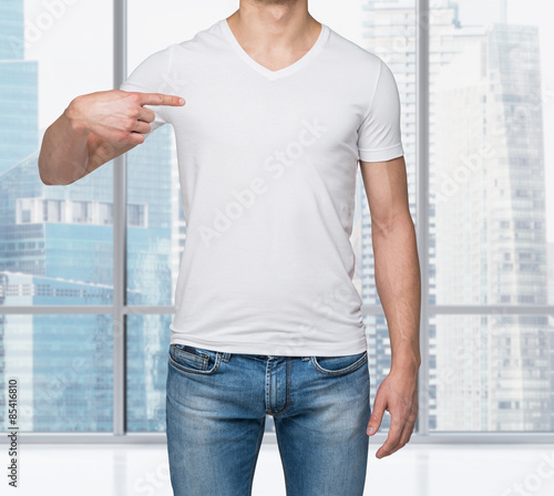 Canvas Print Close-up of a man pointing his finger on a blank t-shirt