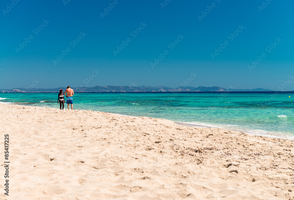 Multi ethnic couple relaxing on a beautiful beach