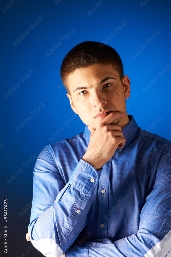 Portrait of thoughtful man against blue Portrait of thoughtful man against blue
