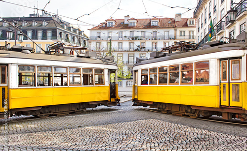 Two famous vintage yellow tramways in the city center if Lisbon.
