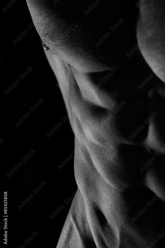 Low key photo of an athletic man with perfect abs Low key photo of an athletic man with perfect abs