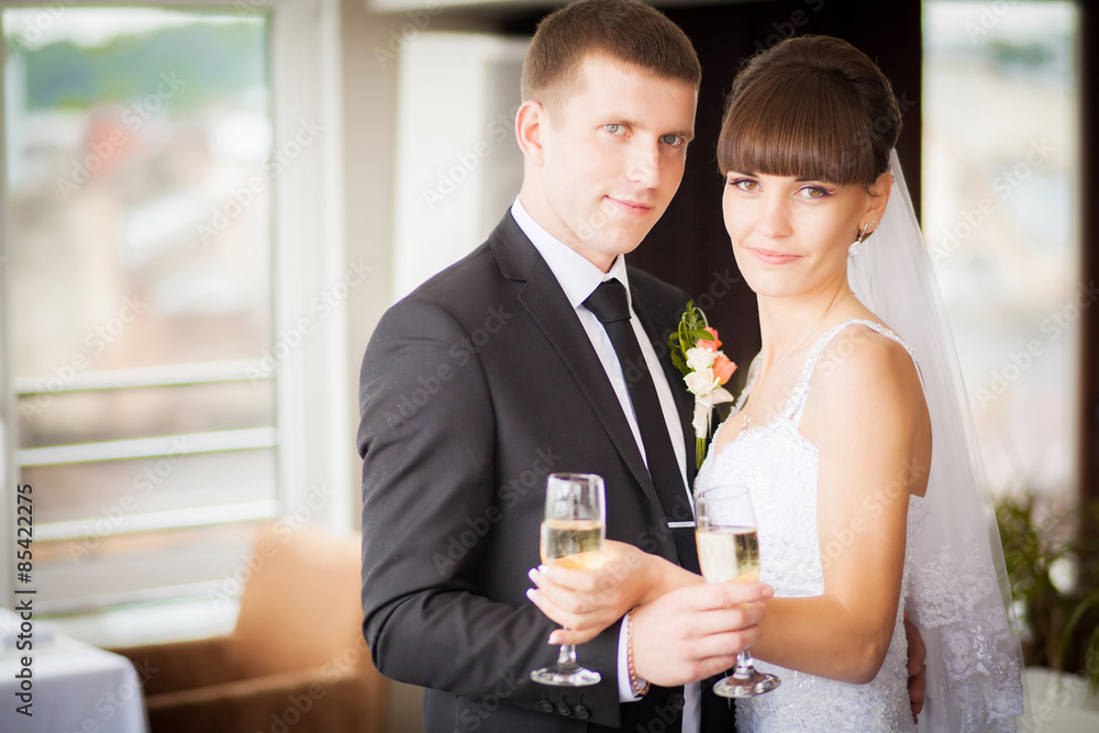 Charming bride and groom on their wedding celebration in a luxur Charming bride and groom on their wedding celebration in a luxur