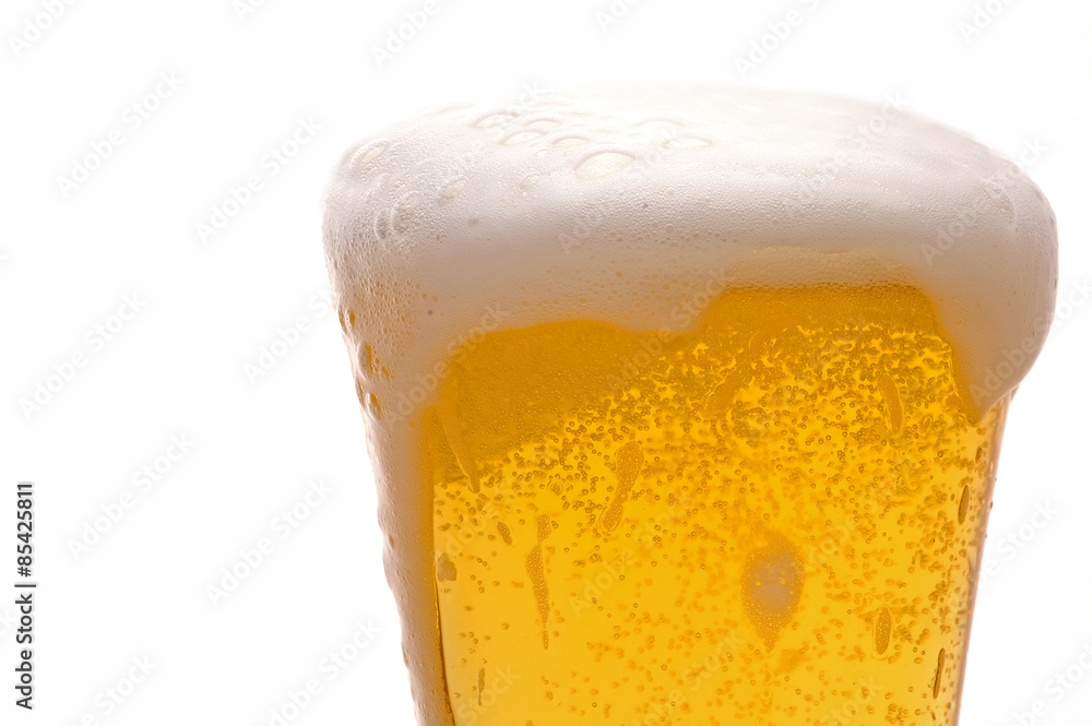 Beer glass with foam dripping down sides Beer glass with foam dripping down sides