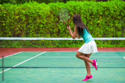 Young active woman playing tennis on tropical vacation © travnikovstudio