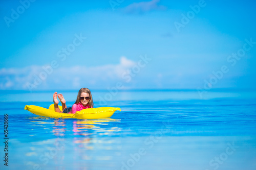Adorable girl with inflatable air mattress in outdoor swimming © travnikovstudio