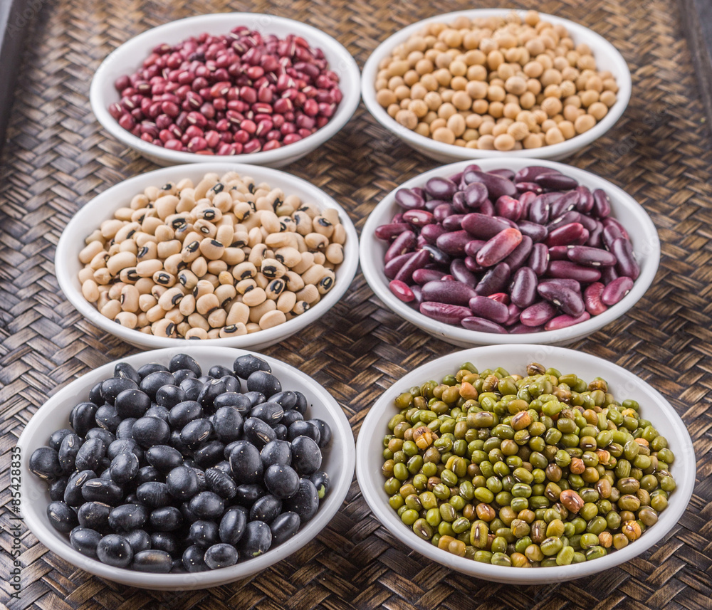 Beans variety in white bowl on in wicker tray Beans variety in white bowl on in wicker tray