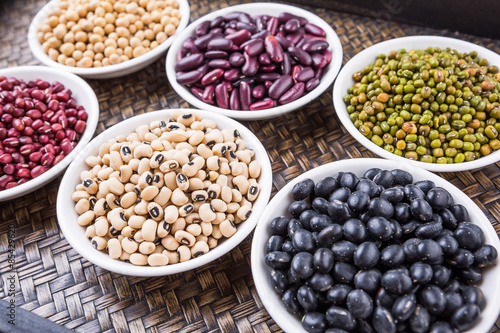 Beans variety in white bowl on in wicker tray