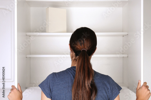 Slika na platnu Woman Looking in Empty Pantry