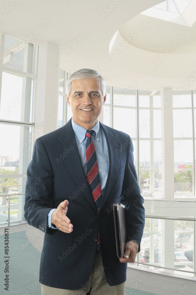Middle aged Businessman in Blue Blazer Handshake