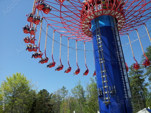 Aerial swing ride  at theme park with trees
