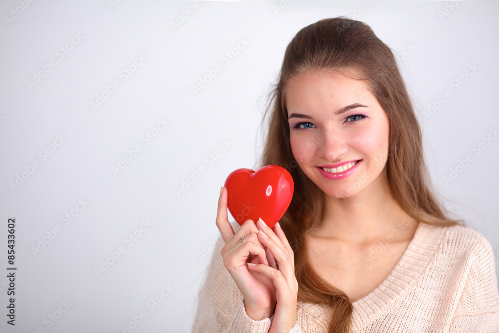 Portrait of beautiful happy woman holding a symbol heart. Portrait of beautiful happy woman holding a symbol heart.