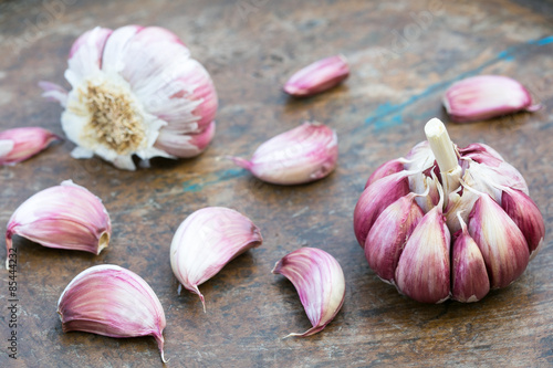 Garlic bulbs and cloves on wooden background