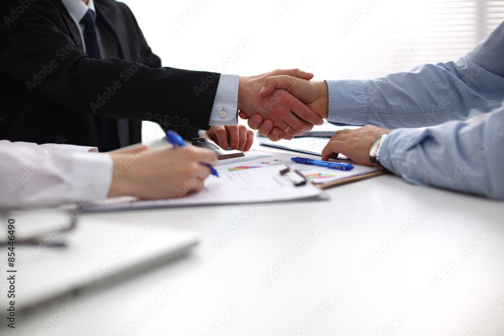 Closeup of a business handshake, on white background Closeup of a business handshake, on white background