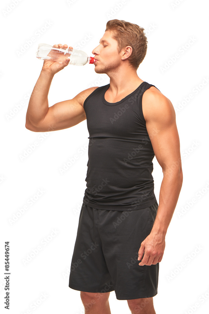 Thirsty handsome muscular young sportsman drinking water Thirsty handsome muscular young sportsman drinking water