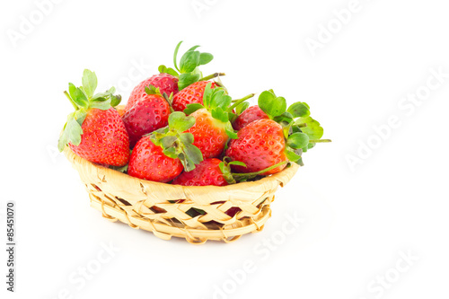 Handful of strawberries in a wicker basket