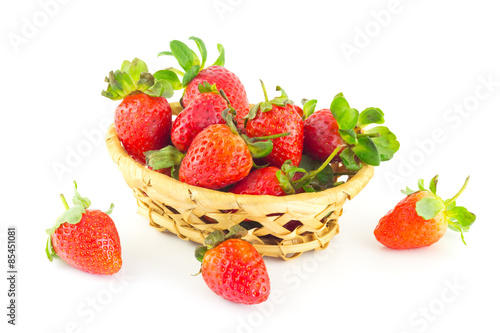 Handful of strawberries in a wicker basket