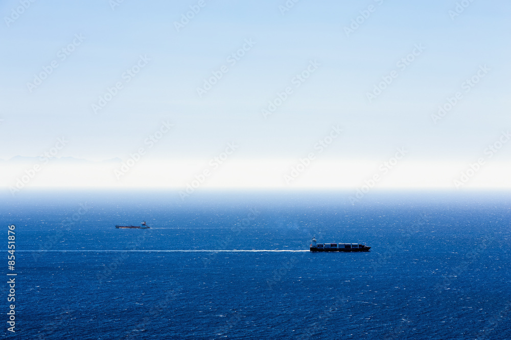Cargo ships with containers in ocean