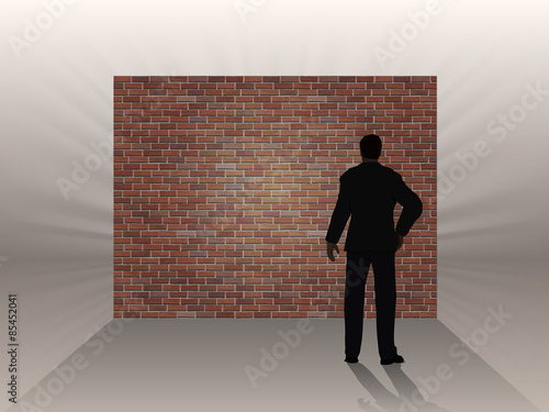 Brick wall and thinking man