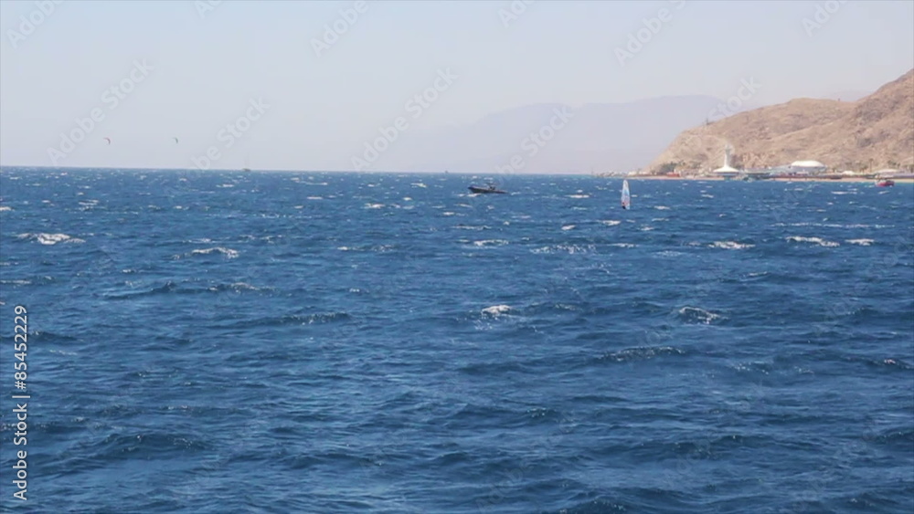 The Gulf of Eilat - Windsurfing and boats sailing in the Red Sea.
Eilat's Underwater Observatory appears on the horizon. The Gulf of Eilat - Windsurfing and boats sailing in the Red Sea.
Eilat's Underwater Observatory appears on the horizon.