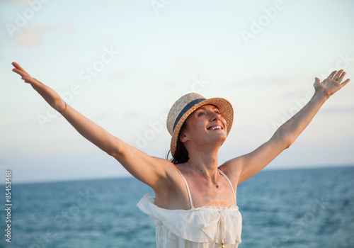 Happy woman  rejoices at summer vacation photo