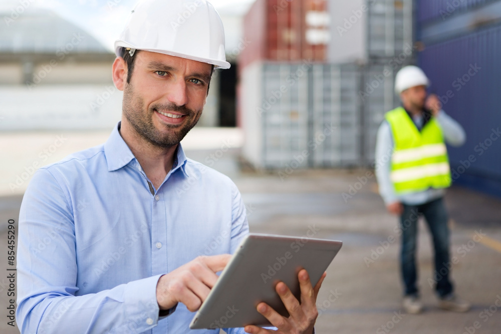 Young Attractive engineer using tablet on the dock Young Attractive engineer using tablet on the dock