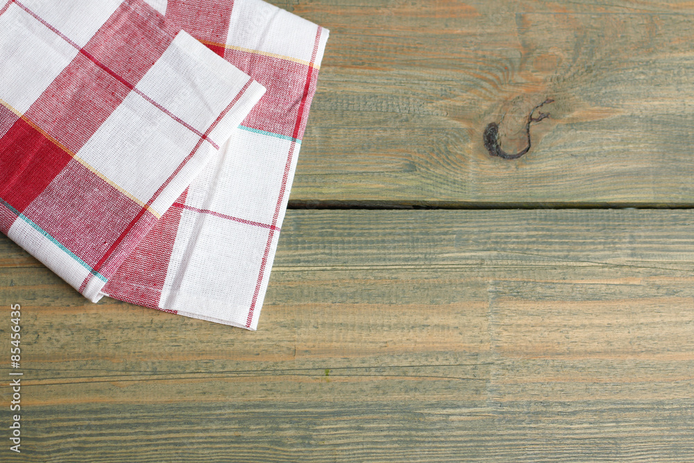 Kitchen towels, napkins on wooden background
