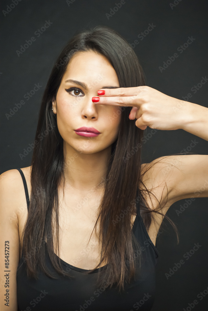 Obraz premium Beautiful Woman covering one eye with her hand