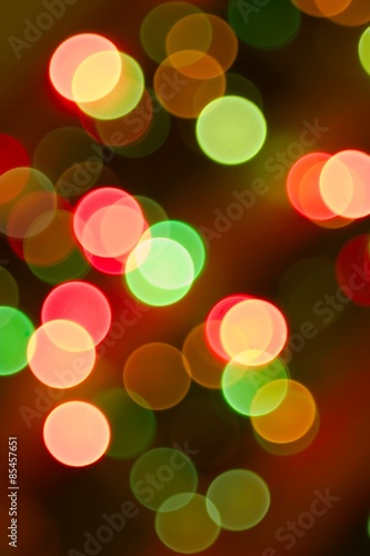 Brightly colored Christmas lights on a Christmas tree. Forced out of focus.