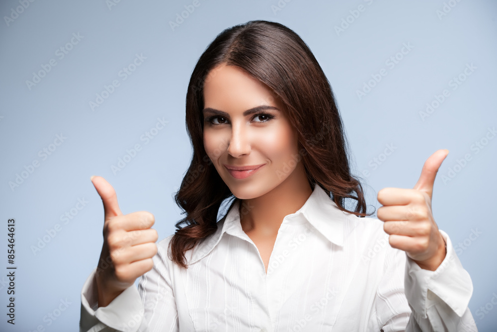 businesswoman, showing thumb up hand sign gesture , over grey businesswoman, showing thumb up hand sign gesture , over grey