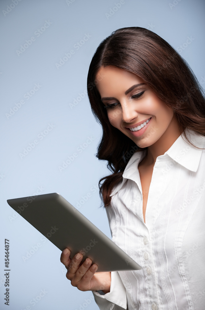 businesswoman using no-name tablet pc, over grey businesswoman using no-name tablet pc, over grey