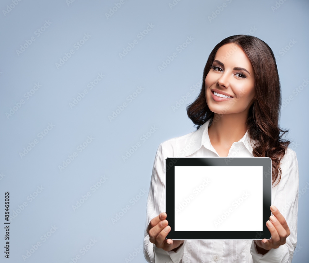 Businesswoman showing blank tablet pc, on grey, with copyspace Businesswoman showing blank tablet pc, on grey, with copyspace