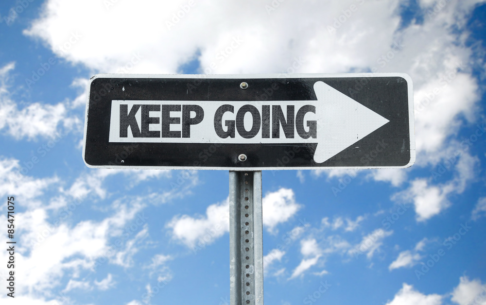 Keep Going direction sign with sky background Keep Going direction sign with sky background