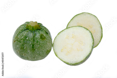 Round zucchini arranged on a white background