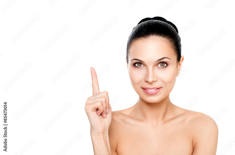 Portrait of a young, happy girl points finger up. Looking to the side. Isolated on white background. Portrait of a young, happy girl points finger up. Looking to the side. Isolated on white background.
