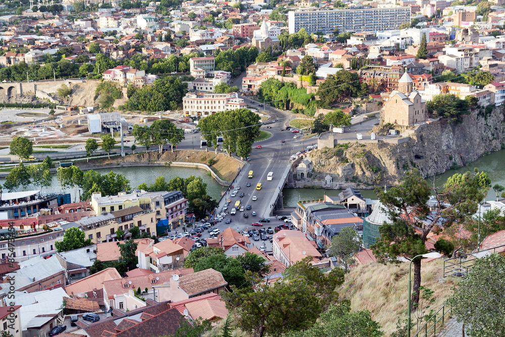 Ropeway cabins and a bridge across the river Mtkvari in Tbilisi.