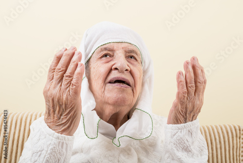 senior woman praying photo