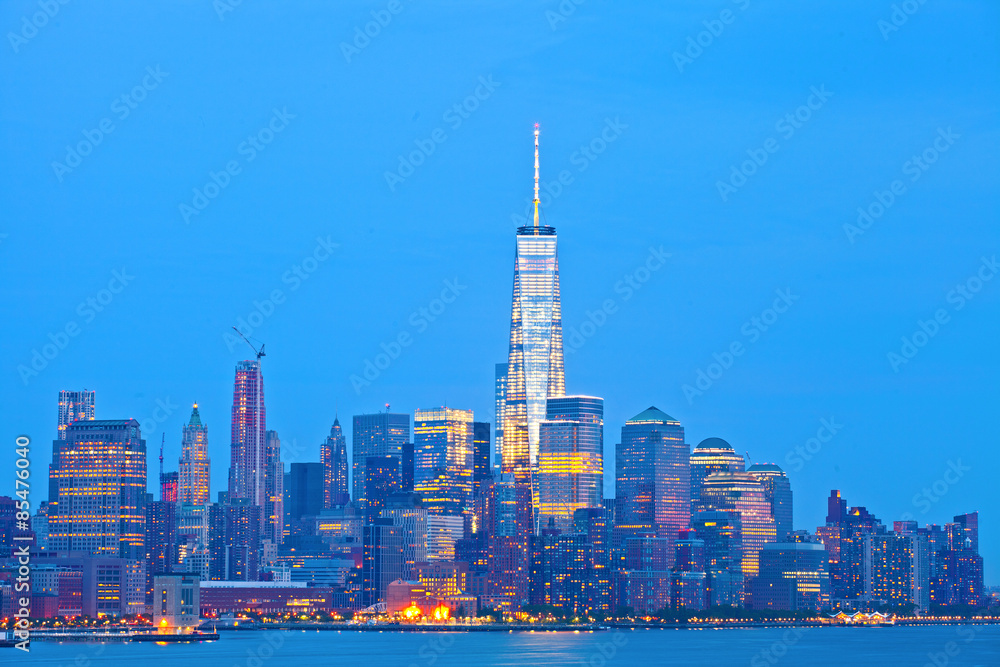 New York City skyline of financial business buildings in Manhattan illuminated at sunset