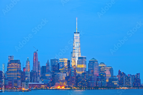 New York City skyline of financial business buildings in Manhattan illuminated at sunset