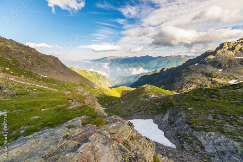 Glowing alpine valley at sunset from above