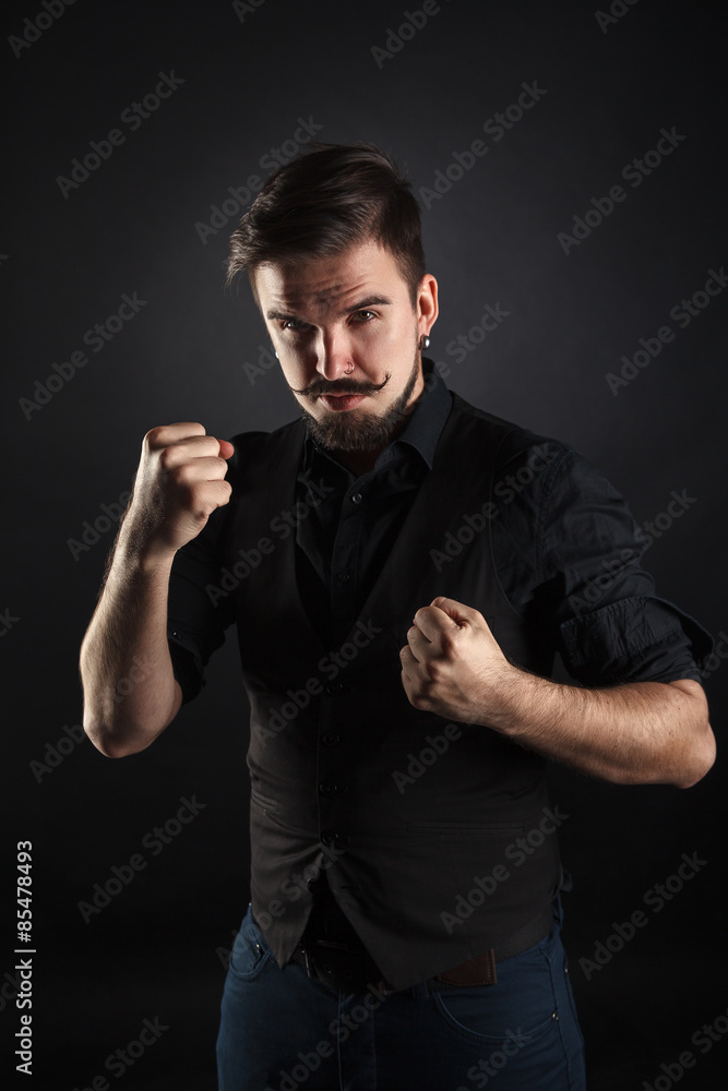 handsome brutal guy with beard on dark background handsome brutal guy with beard on dark background