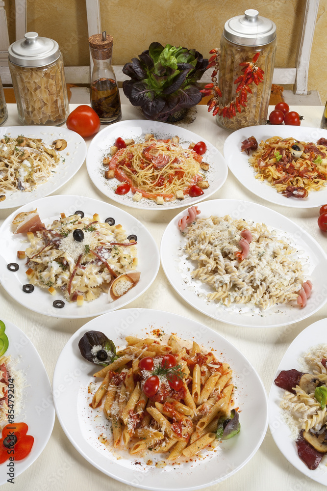 Variety of prepared pasta served on the table. Variety of prepared pasta served on the table.