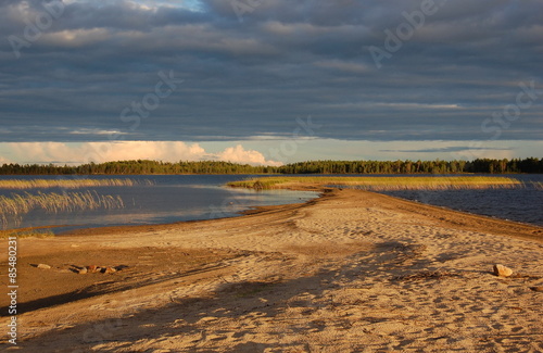 Picturesque sandy spit on forest lake. Karelia  Russia.
