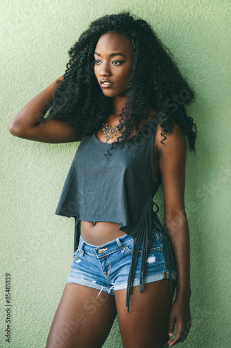 Fashion model in fringe top and blue denim short shorts