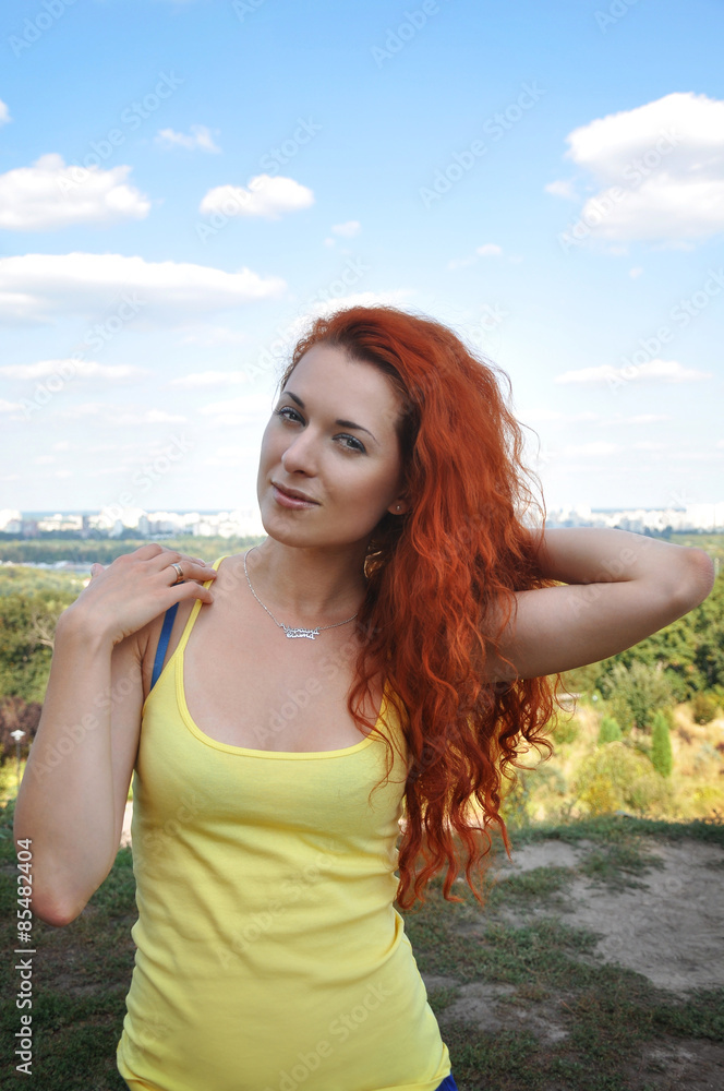 Red-haired girl in the yellow-blue clothes