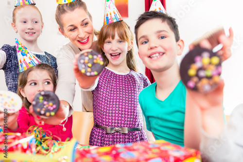 Kids showing muffin cakes at birthday party